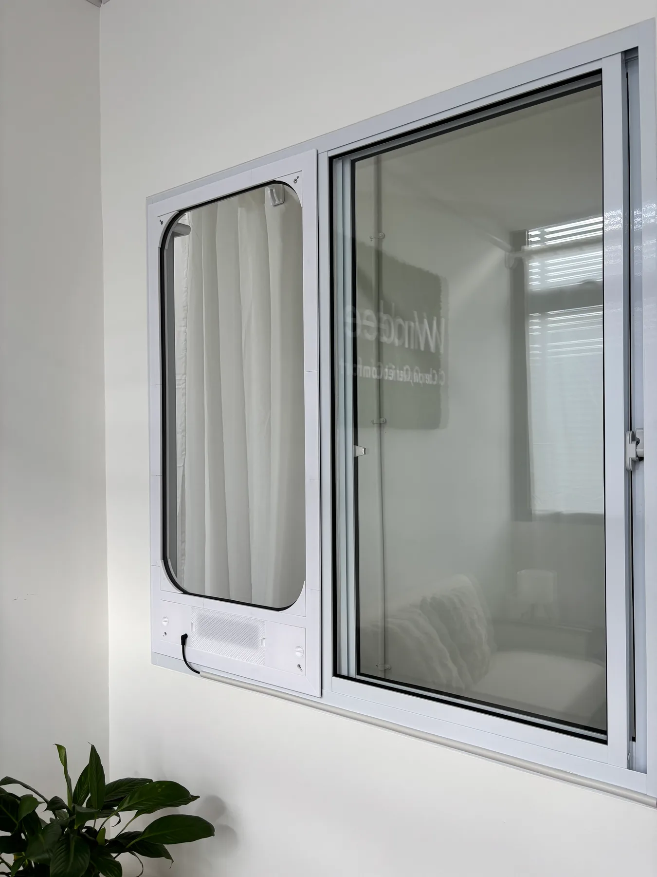 White AireeFit panel installed beside a sliding window