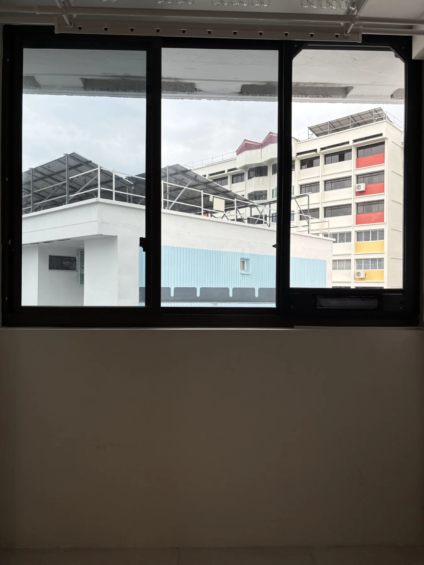 Black AireeFit panel installed beneath a window